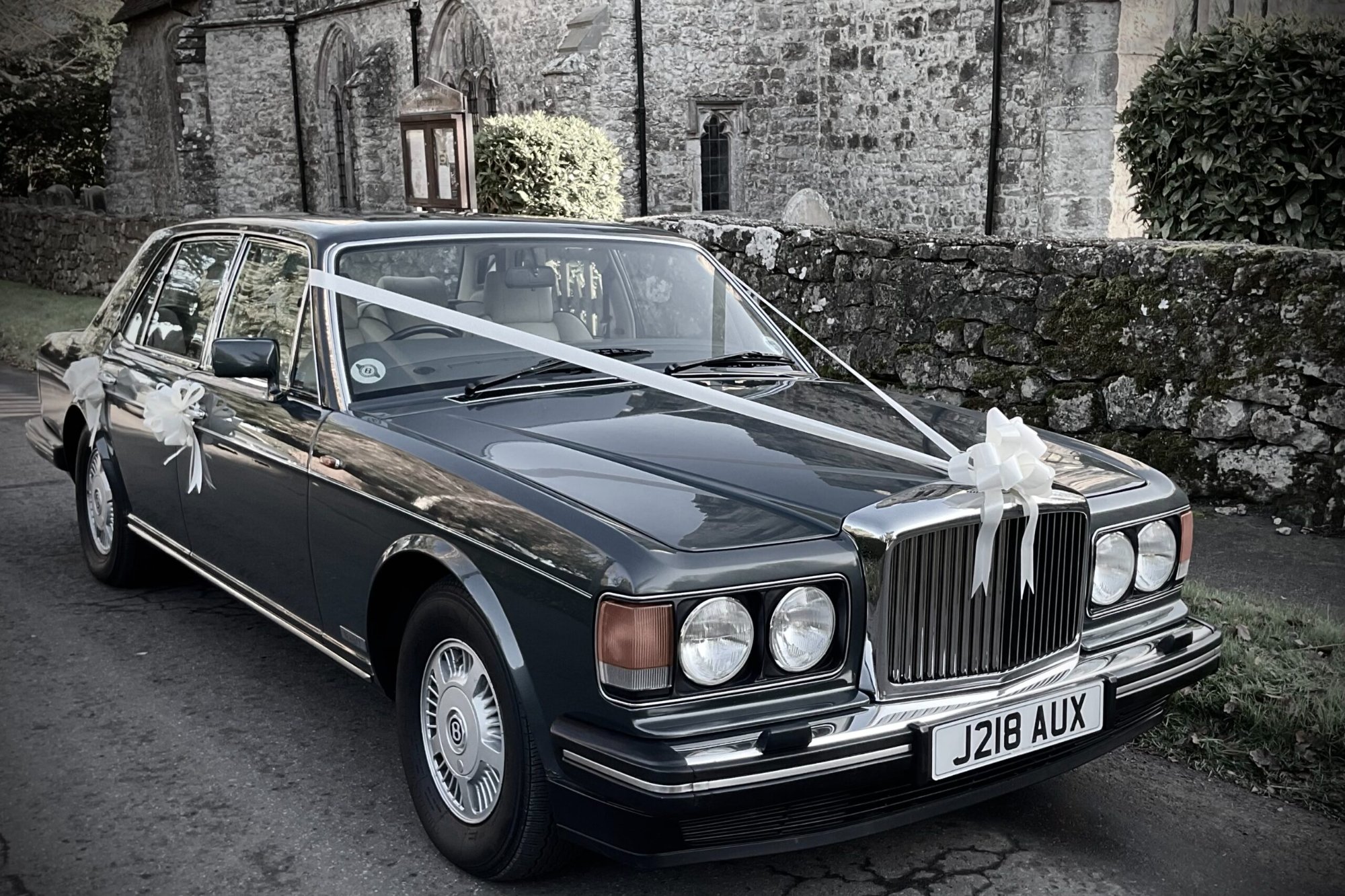 Bentley dressed with wedding ribbons